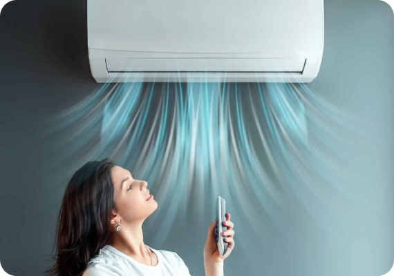 Woman controlling an air conditioner