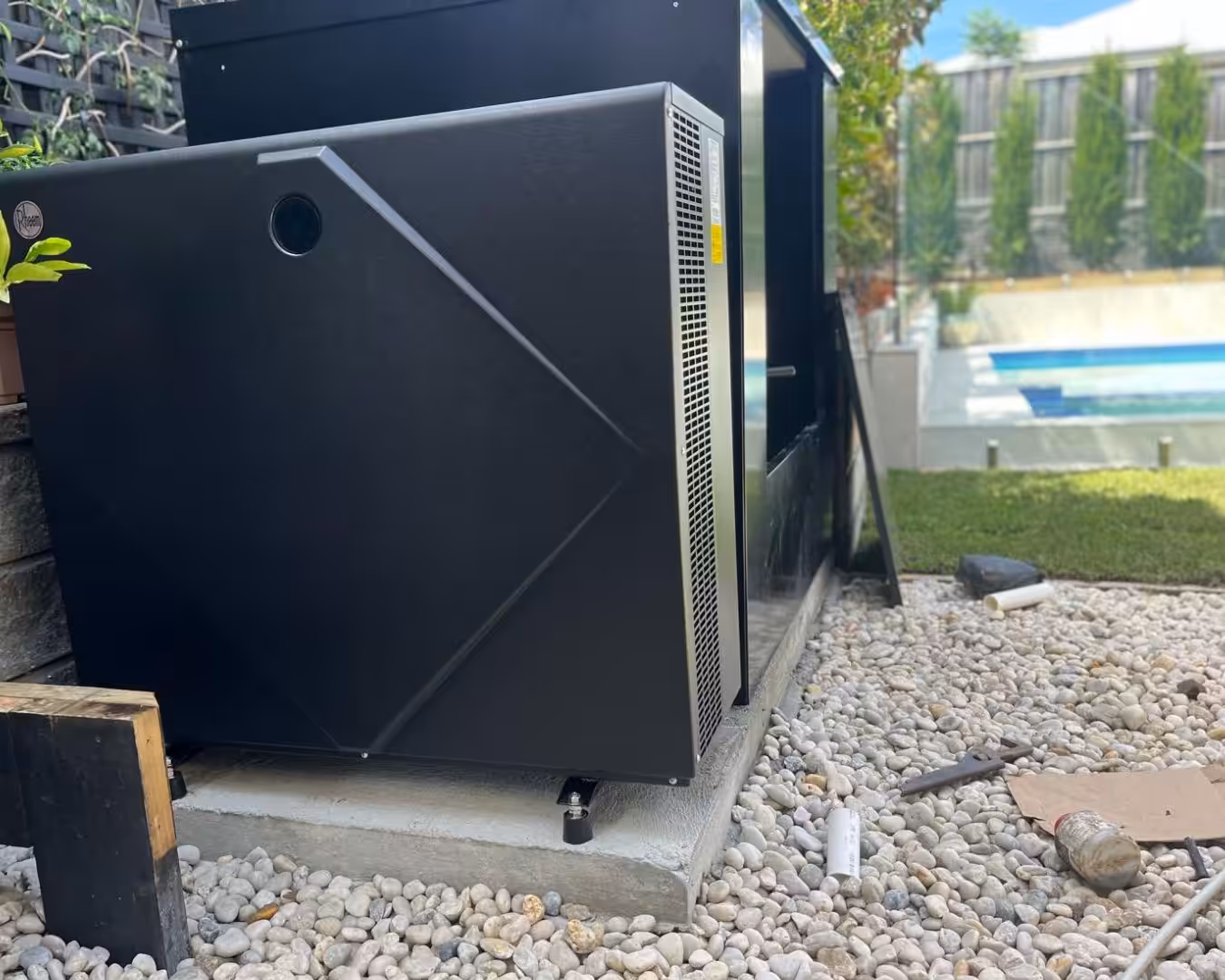 A pool heat pump near a pool