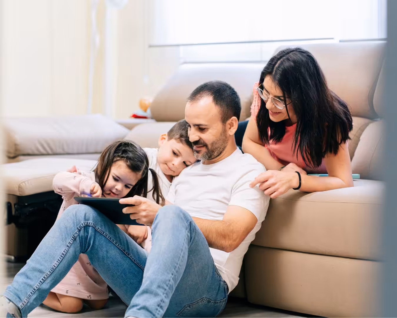 Family of four watching on a tablet