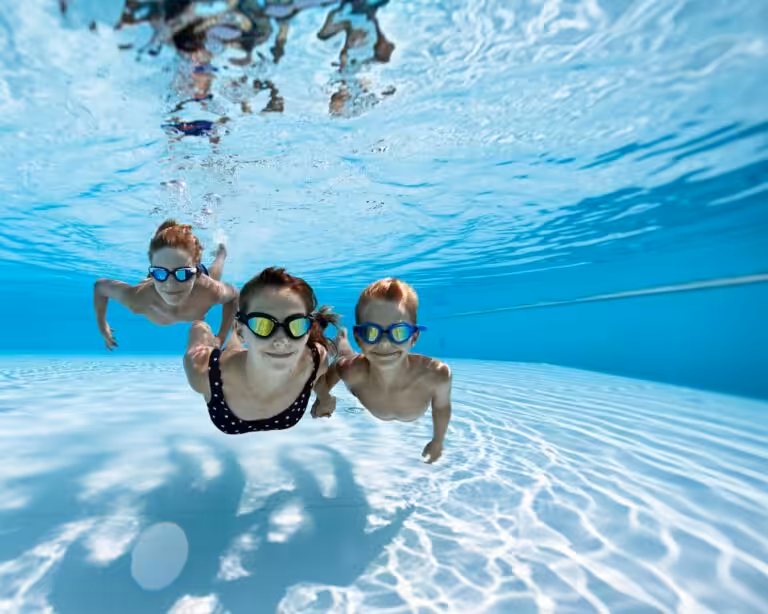 Two boys and a girl enjoying the pool