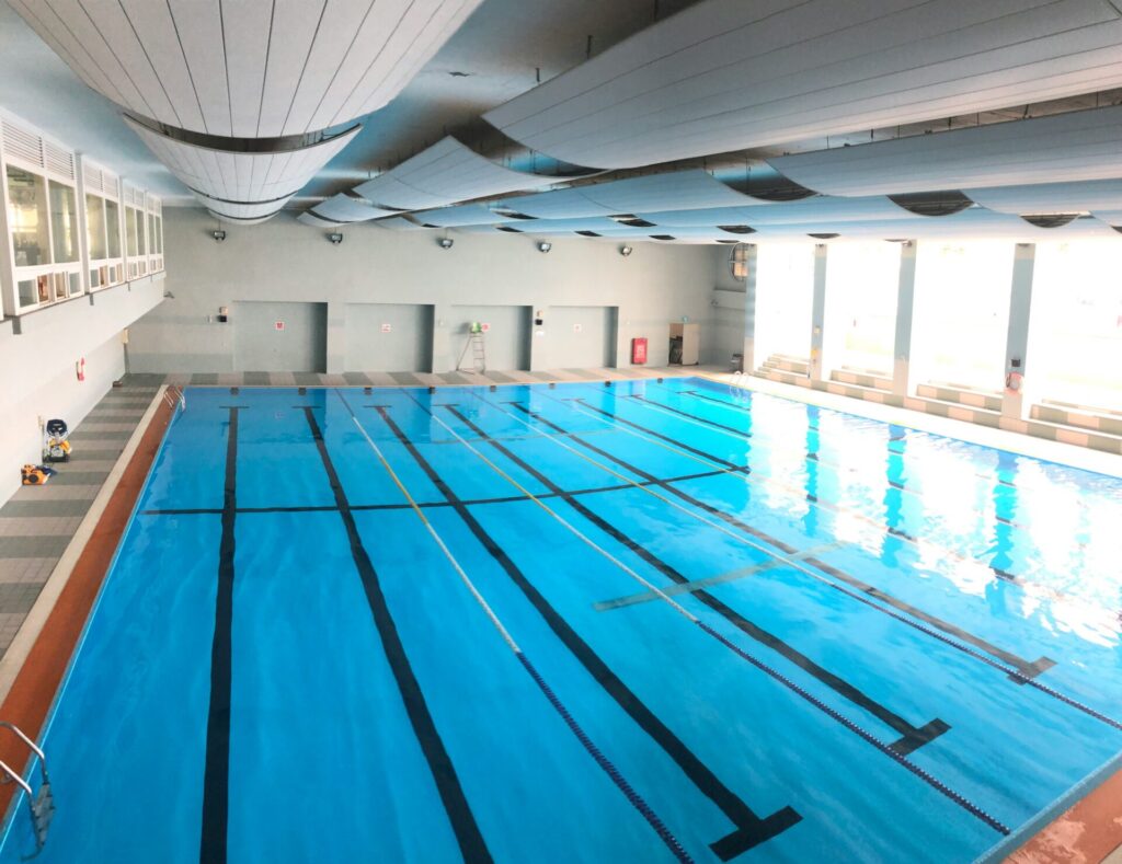 Indoor lap pool with marked lanes and large windows