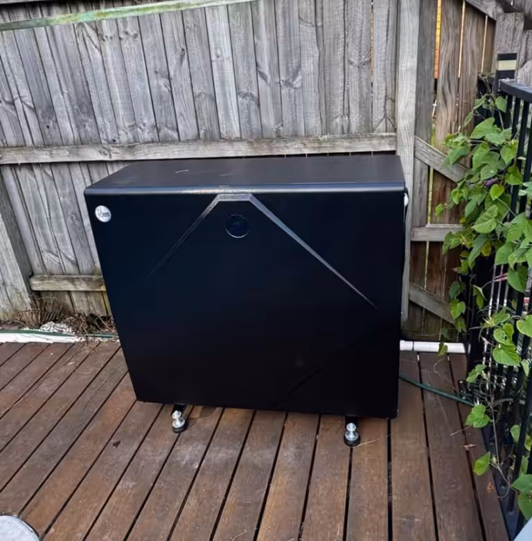 Rheem pool heat pump installed in a corner outdoor area